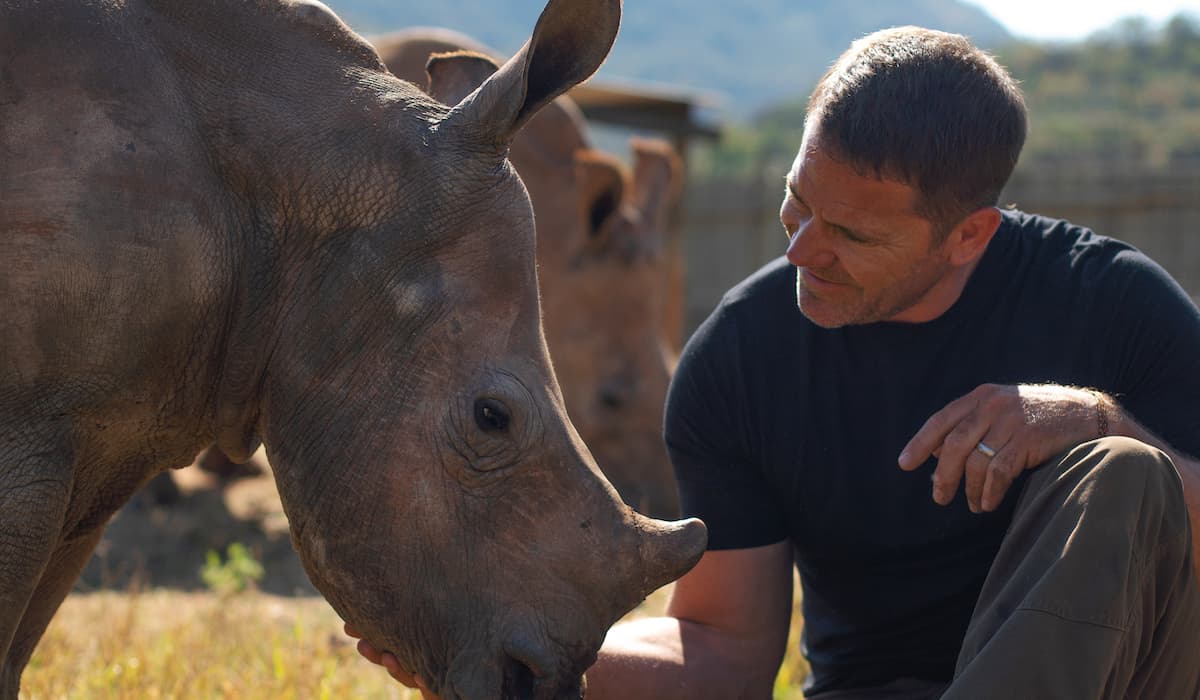 Man touching Rhino 