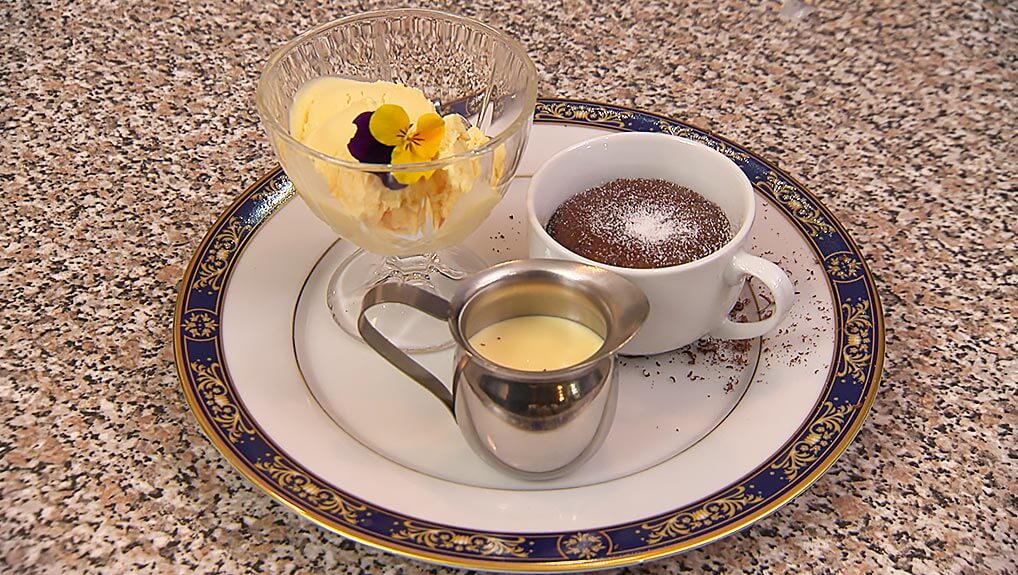 Bittersweet chocolate soufflé served with crème anglaise, and a Scoop of old-fashioned home-made vanilla bean ice cream