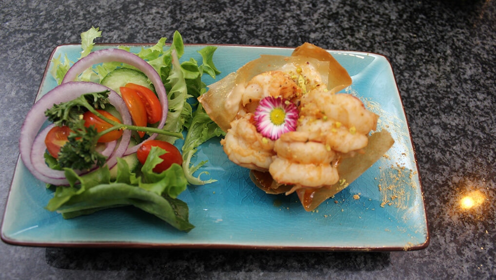 Chilli Lime garlic Prawn s served on phyllo pastry topped with Pistachio sweet chilli mayo sauce